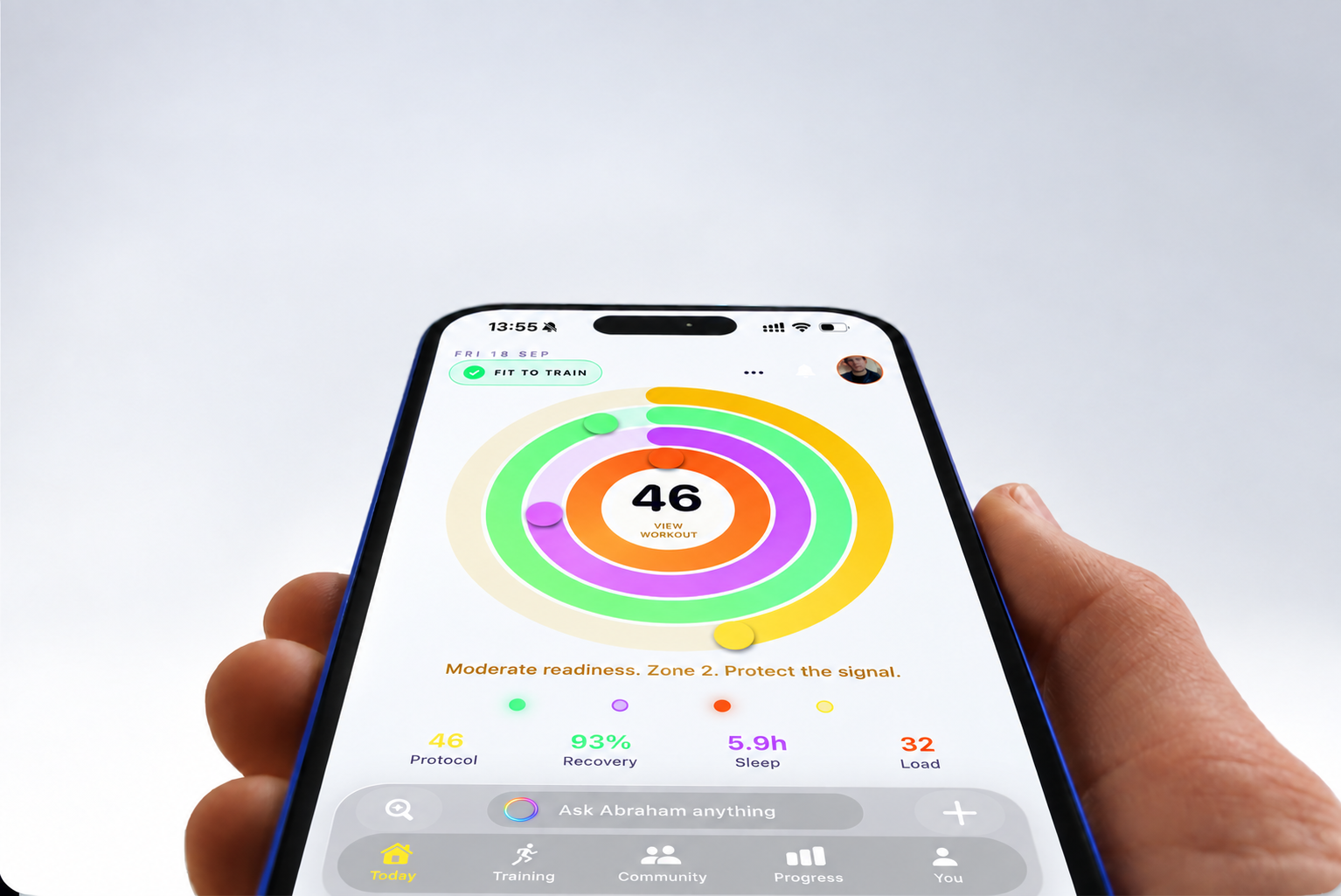 A hand holding the Unbroken app with colourful training, recovery and sleep rings