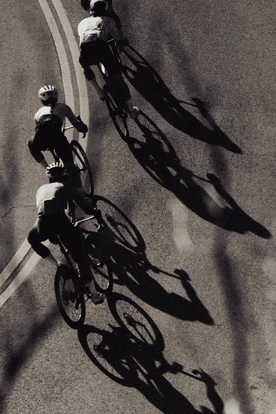 Riders casting long shadows across the road