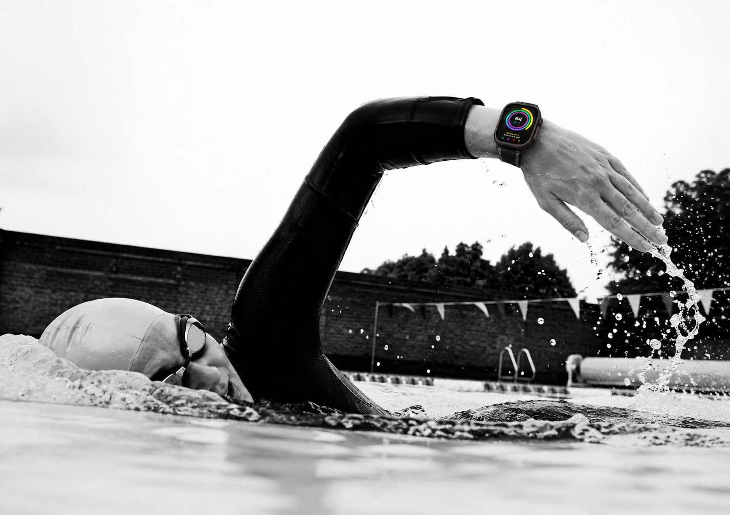 Open-water swimmer wearing Apple Watch — Protocol Score showing on the wrist mid-stroke